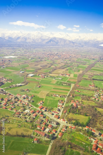 Aerial view of green rural landscape and houses with brown roofs