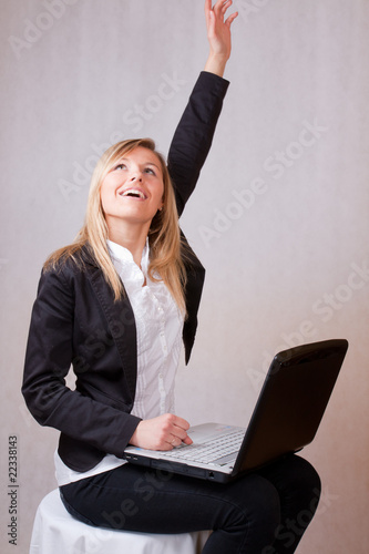 Happy business young woman with laptop