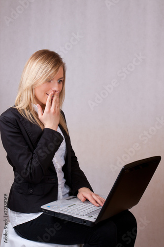 Surprised business young woman with laptop