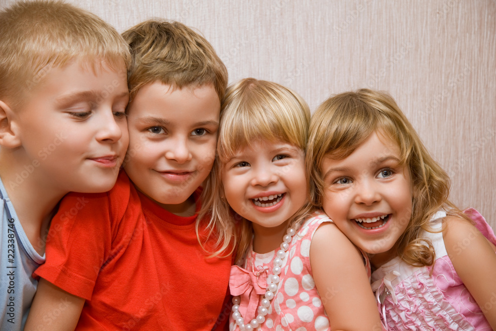 Laughing children four together in cosy room Laughing children four together in cosy room