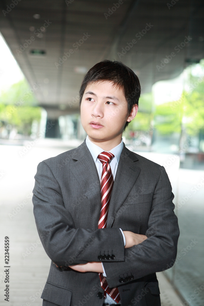 a yong Asiatic businessman is walking outdoor at night a yong Asiatic businessman is walking outdoor at night