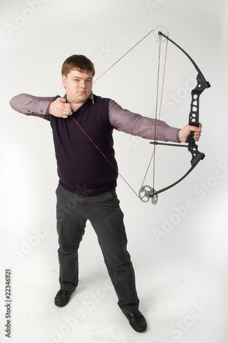 Man shoots compound bow. Isolated on white background