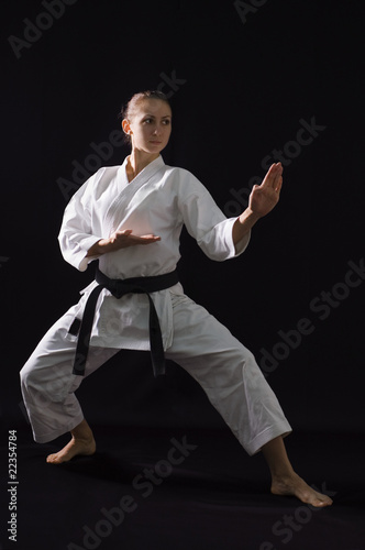 karateka girl on black background studio shot