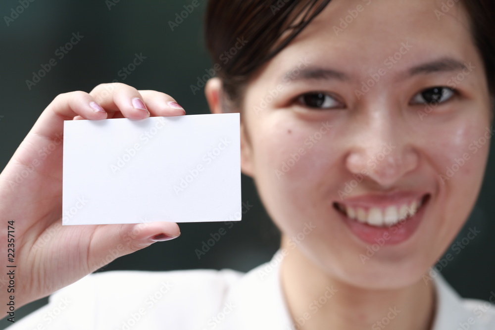 young asian business woman holding a card young asian business woman holding a card