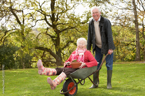 Senior Couple Man Giving Woman Ride In Wheelbarrow