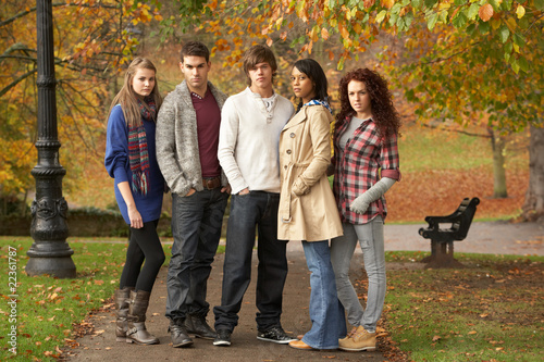Group Of Five Teenage Friends Having Fun In Autumn Park