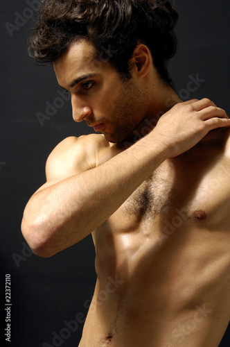 young sensual man on a black background