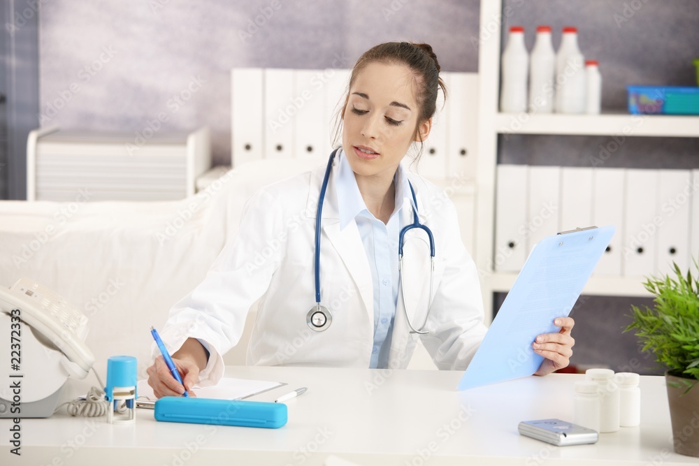 Doctor working at desk Doctor working at desk
