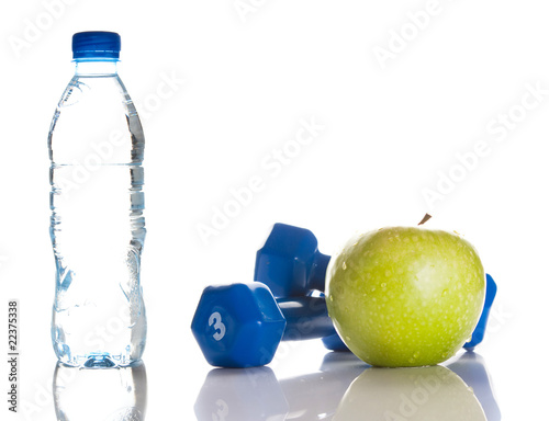 Dumbbells, green apple and a bottle of fresh water
