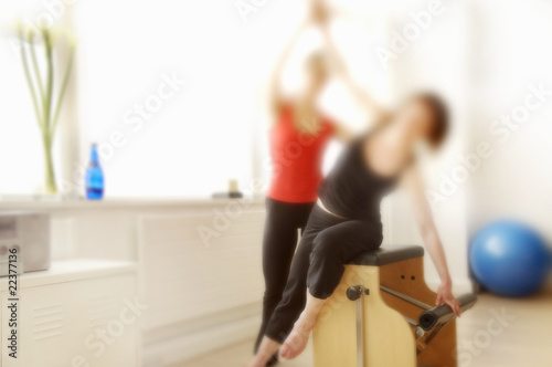Plilates chair in use by two women, soft focus