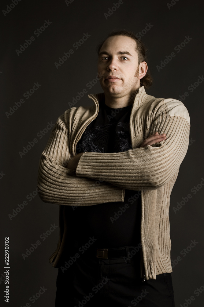 Portrait of young confident man. Arms folded.