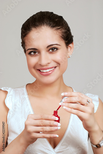 young woman using nail polish