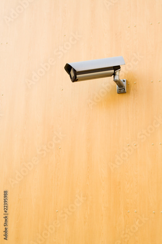 Security camera over brown background