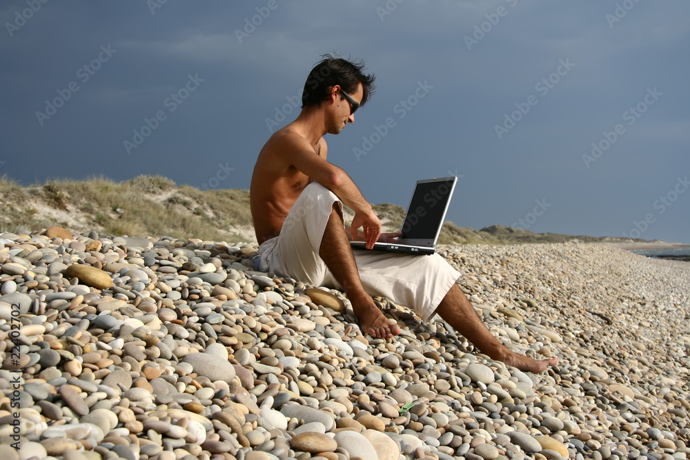 Surfer working on his laptop