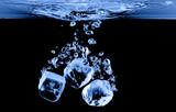 ice cubes dropped into water with splash
