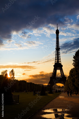 Eiffel Tower against a colorful sunset after rain