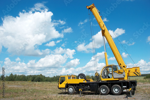 mobile crane with risen boom outdoors photo