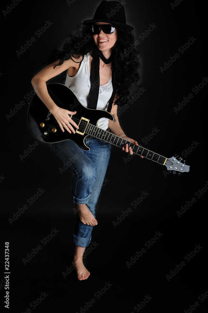 Beautiful smiling girl with a guitar