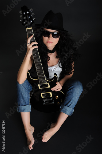 Girl sitting on the floor with a guitar