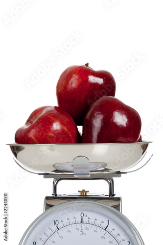 Fruit on a scale with a white background