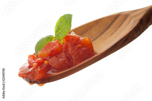 raw tomato pulp with basil over the spoon photo