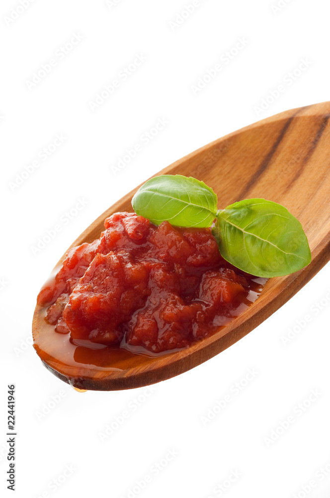 cooked tomato sauce with basil over the spoon