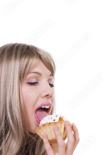 Portrait of a cute blonde licking cream