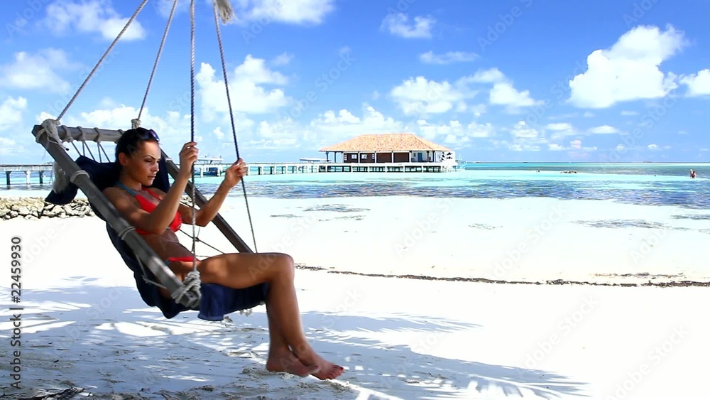 Beautiful and sexy woman resting at Maldives seaside