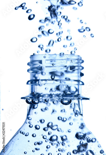 bottle in pure water with waves and bubbles