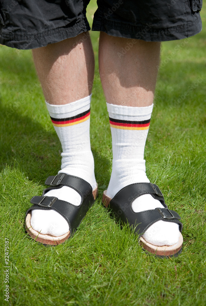 Männerbeine mit Socken und Sandalen Stock-Foto | Adobe Stock