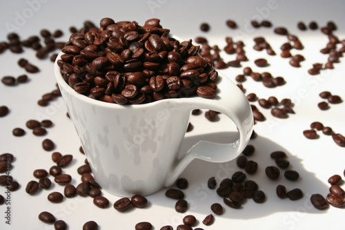 Fresh coffee beans in a white cup