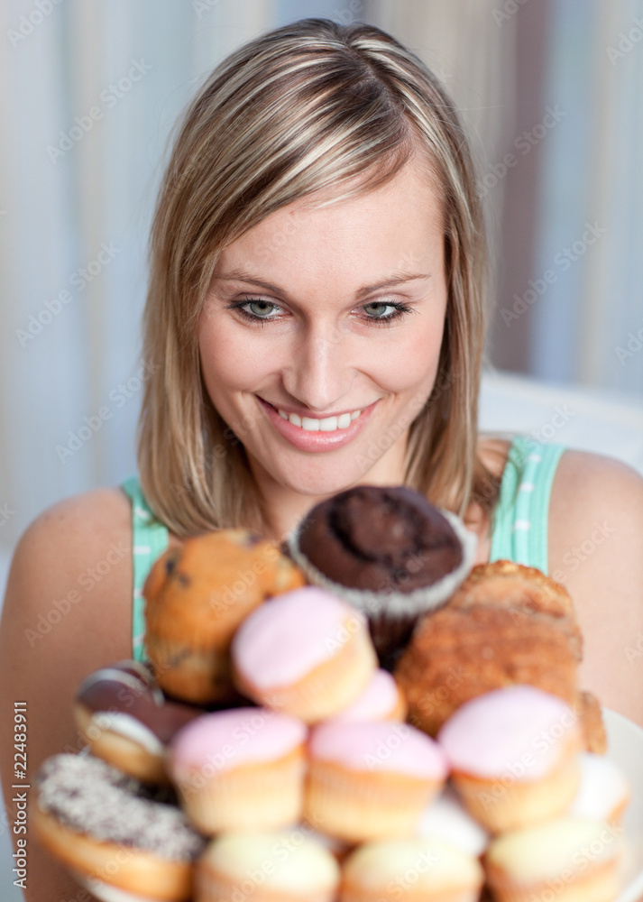 Charming woman holding a plate of cakes Charming woman holding a plate of cakes