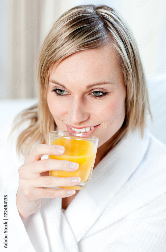 Portrait of a young woman holding an orange juice Portrait of a young woman holding an orange juice