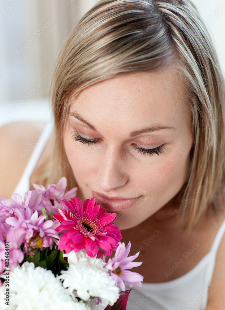 Beautiful woman smelling a bunch of flowers Beautiful woman smelling a bunch of flowers
