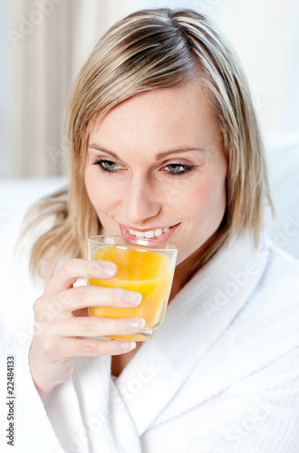 Portrait of a young woman holding an orange juice