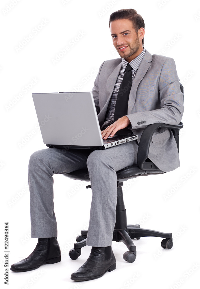 Business man sitting with laptop and smiling Business man sitting with laptop and smiling