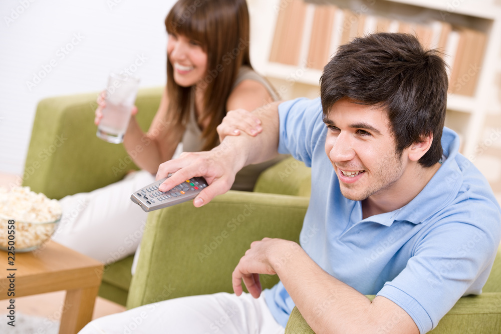 Students - happy teenagers watching television Students - happy teenagers watching television
