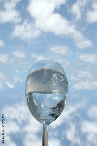 glass of cool water against a blue sky