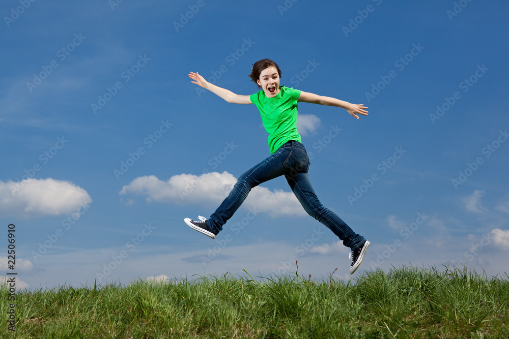 Girl jumping, running against blue sky Girl jumping, running against blue sky