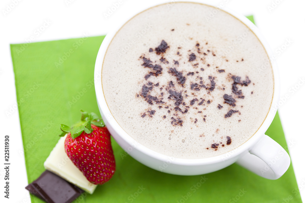 cup of cappuccino with chocolate and strawberry on a napkin cup of cappuccino with chocolate and strawberry on a napkin