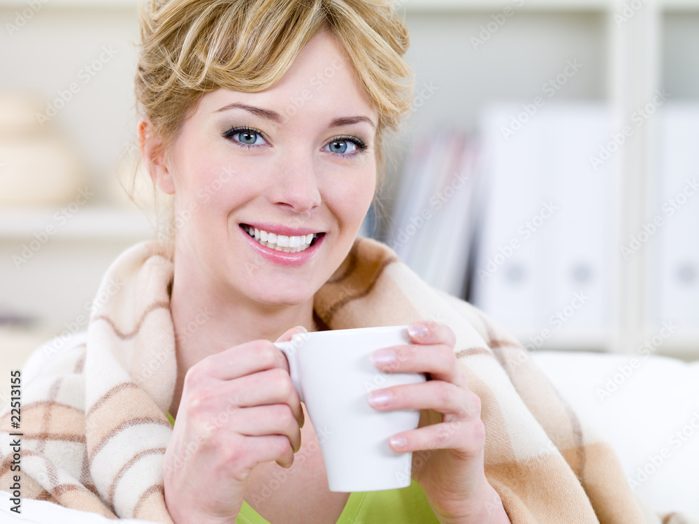 Smiling woman warming with cup Smiling woman warming with cup