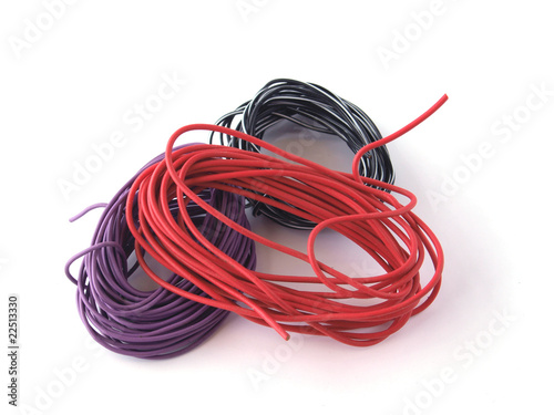 Close up of multicoloured wire on a white background.