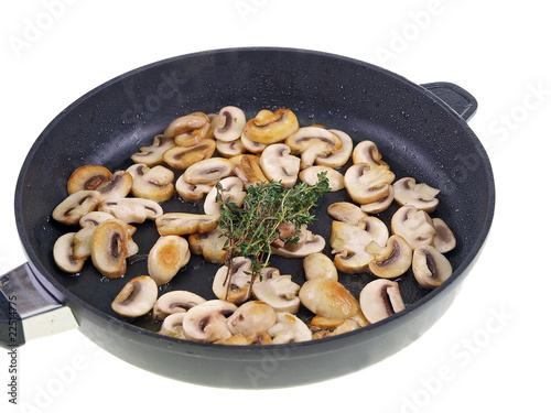 cooking mushrooms in a pan isolated on white background