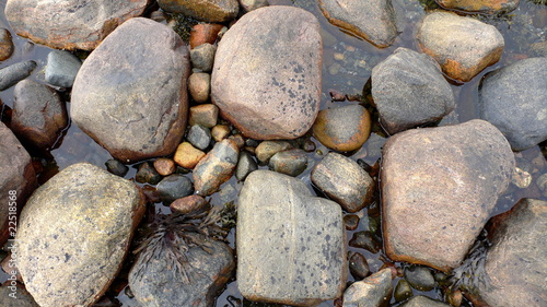 Sea pebble stone around water abstract natural background