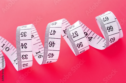 Tape Measure on pink background