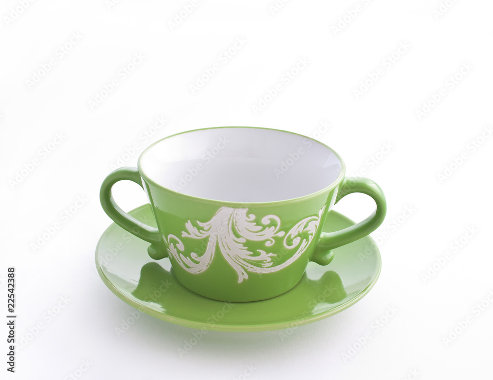 Fototapeta premium Empty green cup on a saucer
