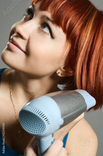 Woman with hairdryer and a hairbrush