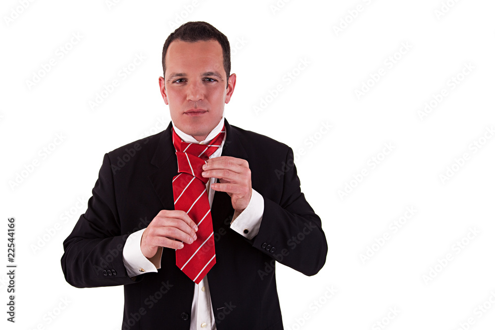 Businessman putting on tie