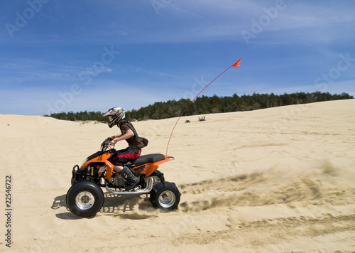 Speeding quad in sand dunes