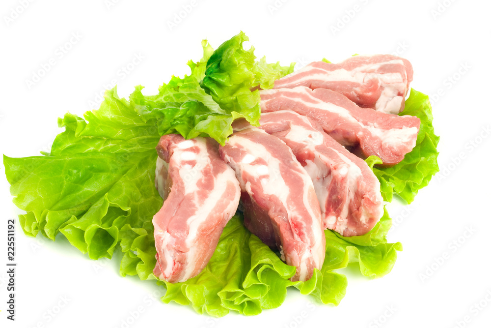 Pork meat pieces on green salad Isolated
